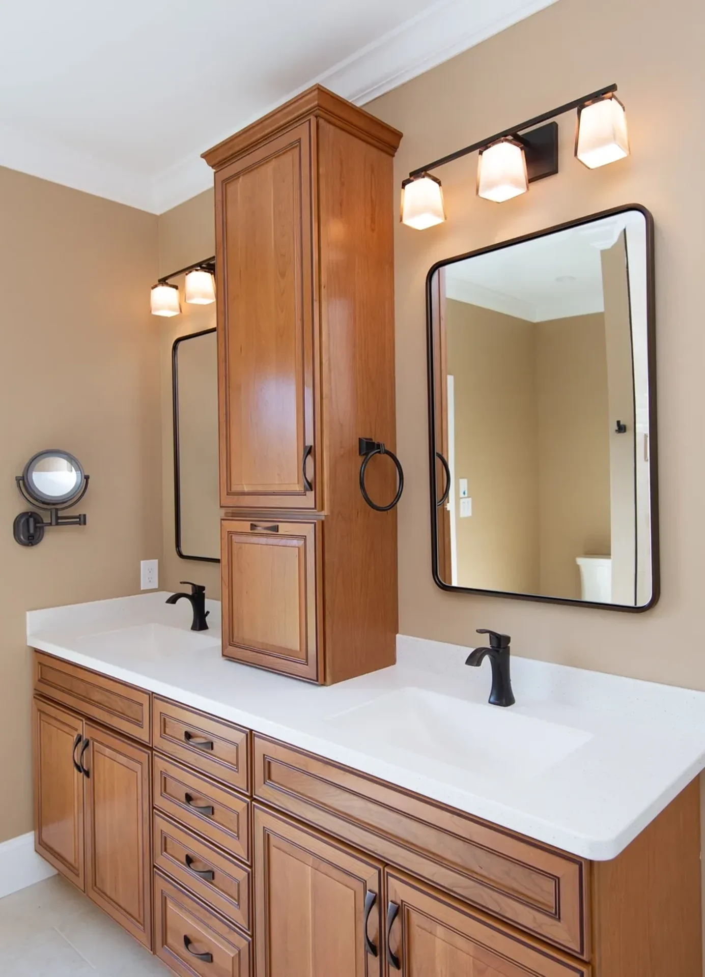 Double sink bathroom with wooden cabinets.