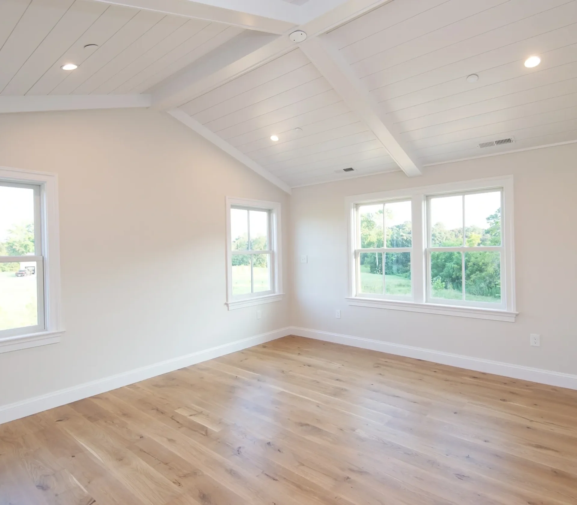 Bright empty room with wooden floors.