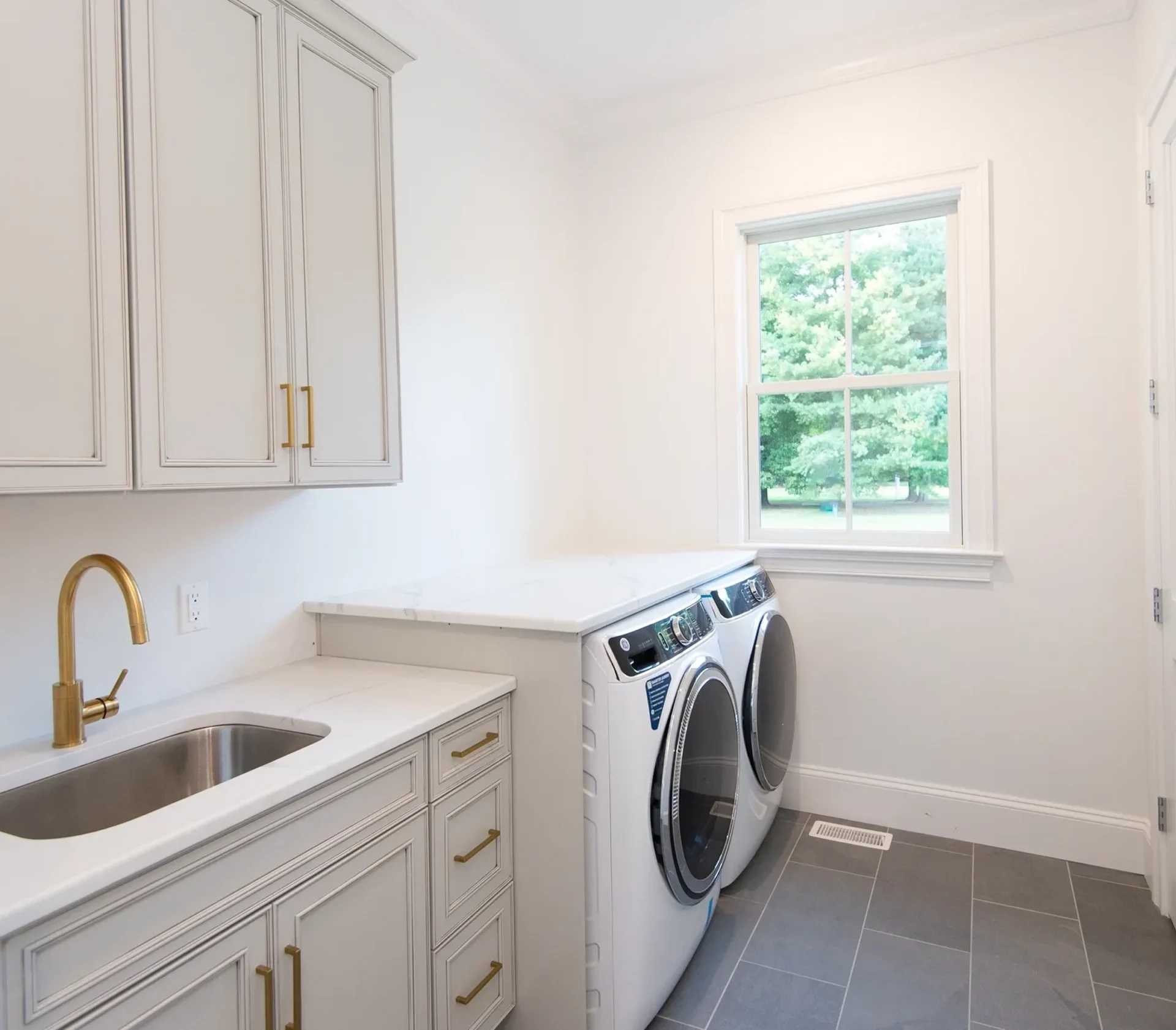 Laundry room with washer, dryer, and sink.