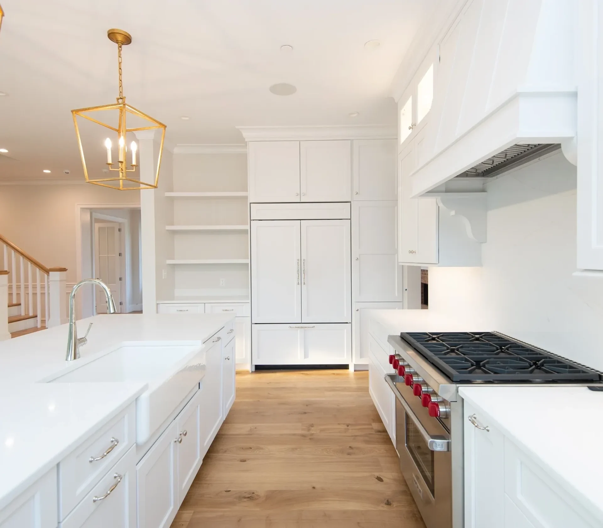 Modern white kitchen with large stove and island.