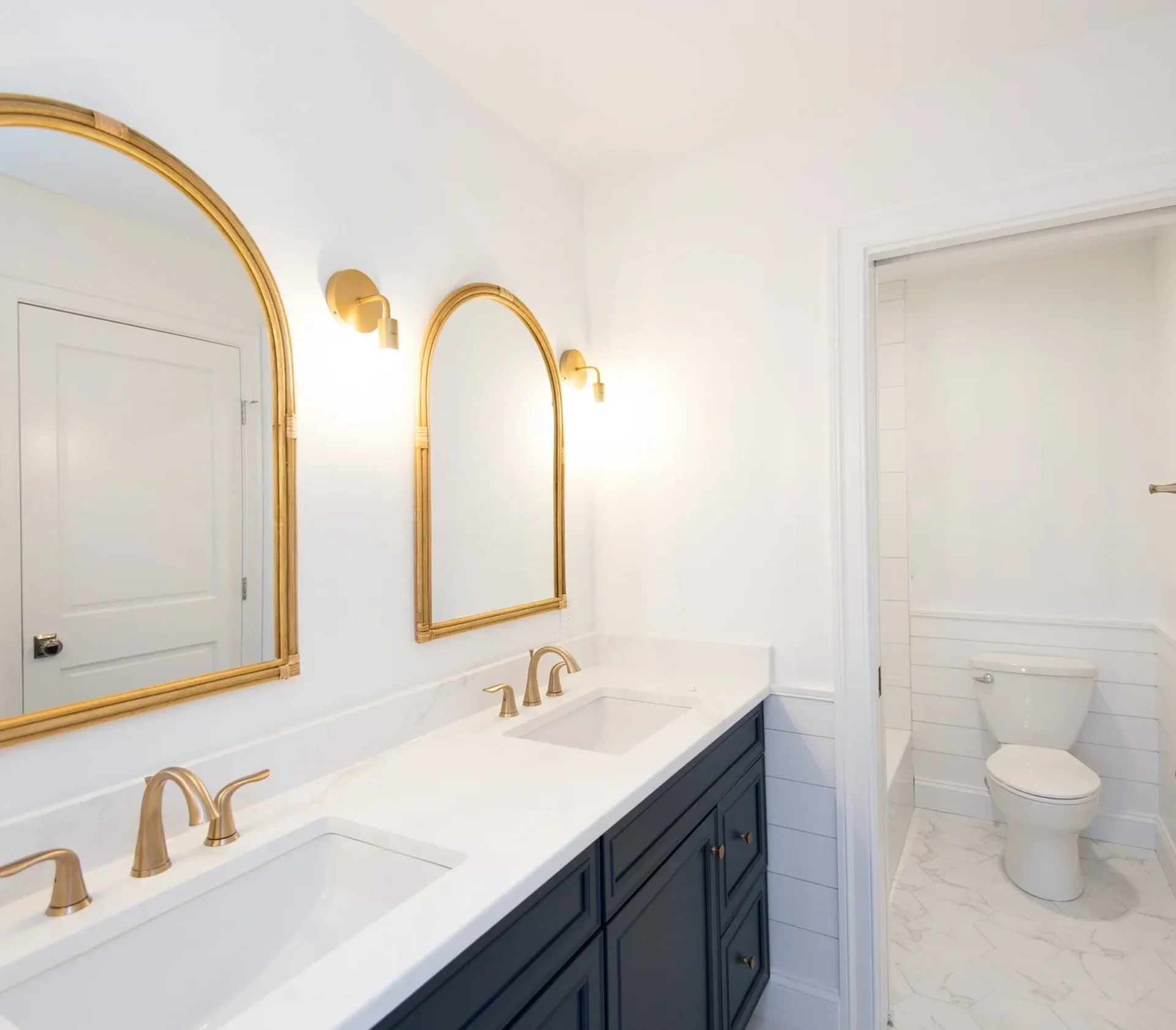 Elegant bathroom with double vanity and mirrors.