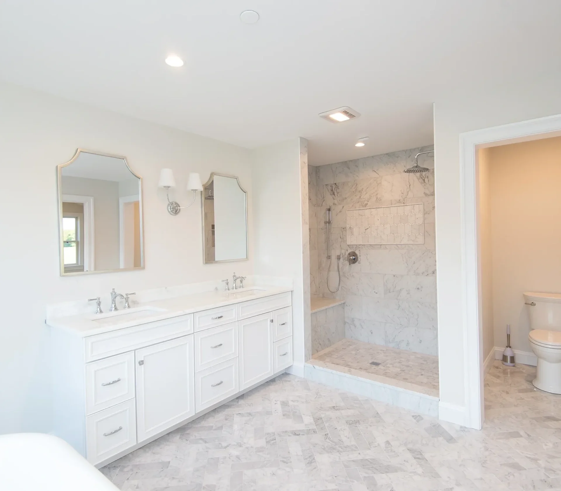 Modern white bathroom with dual sinks.
